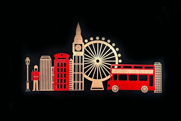 Layered metal relief artwork of the London skyline with red bus and telephone box