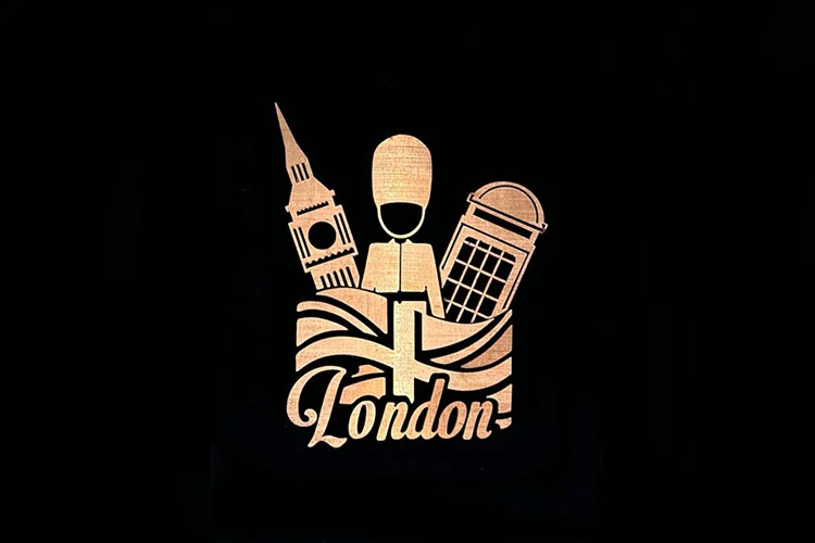 Metal emblem artwork of a Beefeater, Big Ben and telephone box above a London banner